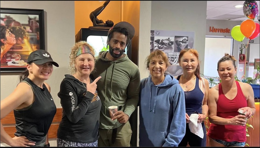Six Yoga Health Center community members smiling together at a celebration